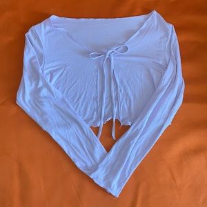 Light purple. Cropped long sleeve with a tie in the front size medium.